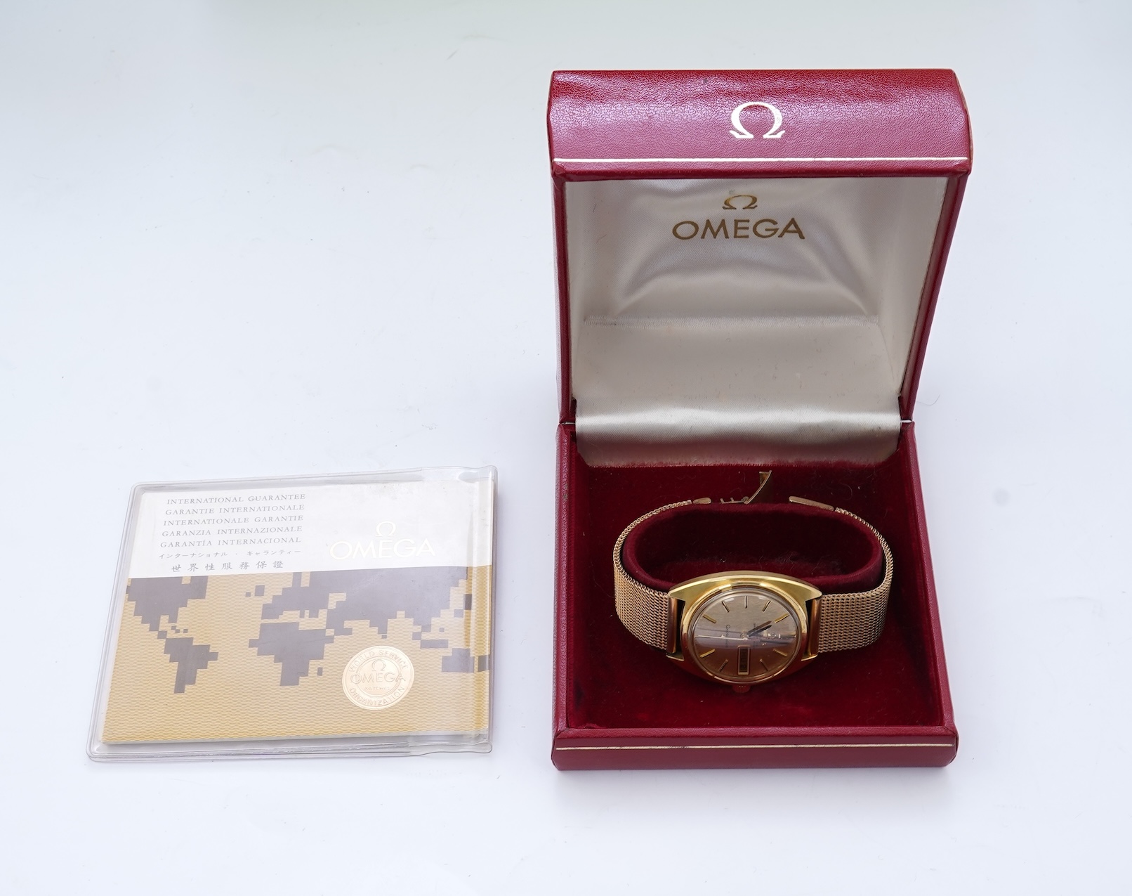 A gentleman's late 1960's 18ct gold Omega Constellation Automatic Chronometer Officially Certified wrist watch, on an associated 9ct gold mesh link bracelet